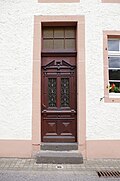 Hellenthal, Im Kirschseiffen 27, house entrance with a stumbling stone in front of it for Wilhelm Hermann.jpg