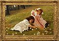 Two girls playing in a field of daisies