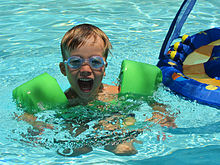 A child swimming with inflatable armbands Lucas in the pool.jpg