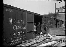 Loading dock with a Michigan Central boxcar in 1920 Michigan Central RR -Men on loading platform (3329275218).jpg