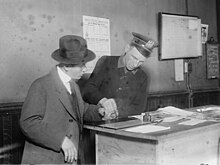 A New York City Police officer fingerprinting a German in 1917 (NYC police) fingerprinting a German (1917) (LOC) (25131923395).jpg