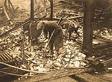 Soldiers of the National Army of the Irish Free State searching through the remains of a fire at the Rotunda Rink, Parnell Square, which was the sorting office of the General Post Office in Dublin (5 November 1922) National Army soldiers search remains of a fire during Irish Civil War 1922 (6314582749).jpg