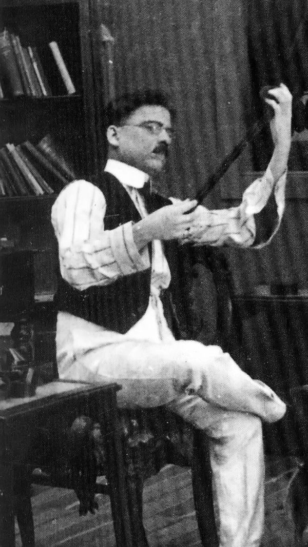 Phalke seated on a chair with a small roll of film in his hands