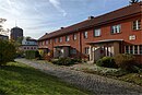 Terraced house settlement, consisting of six apartment blocks and a wash house including a house with a plaque for Hans Fallada