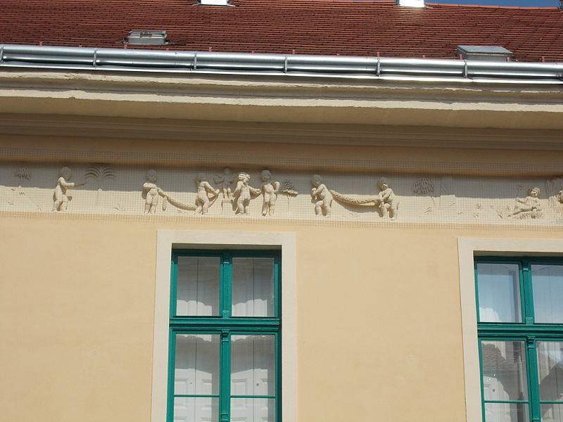 File:Relief shows a forging putto (right) her friends adorned Cupid statue at the altar. Listed house ID 3833. 18th century origin. Baroque and early neoclassical.- 13, Fő St., Országzászló Sq., Downtown, Székesfehérvár.JPG