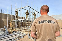 A sapper of the Royal Engineers watches as soldiers reinforce security at FOB (Forward Operating Base) Shawqat in Afghanistan. Royal Engineers Working at FOB Shawqat MOD 45155378.jpg