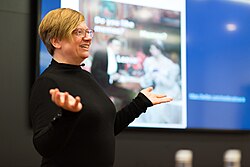 Sandra Fauconnier shrugging while giving a presentation at Public Domain Day 2018