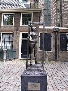 Statue to honor the sex workers of the world. Installed March 2007 in Amsterdam, Oudekerksplein, in front of the Oude Kerk, in Amsterdam's red-light district De Wallen. Titled Belle, the inscription to the piece says "Respect sex workers all over the world." Sex worker statue Oudekerksplein Amsterdam.jpg