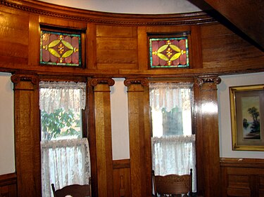 View of the dining room alcove detailing the stained glass windows, pillars, and decorative dentil molding. Simmons-Bond House, diningroom stained glass window.JPG