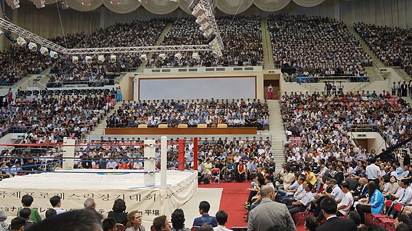 Spectators gather in Pyongyang, North Korea for Antonio Inoki's Pro Wrestling Friendship Games. A traditional wrestling ring can be seen in the lower 