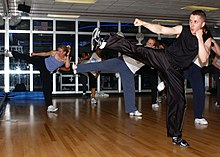 US Navy 040329-N-9296W-004 Lt. Dave Merrifield and other students enjoy a kickboxing workout from instructor Laura Galloway in the Fit Zone Gym aboard Naval Support Activity Naples, Italy.jpg