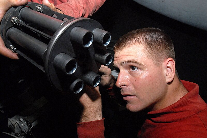 File:US Navy 080919-N-3610L-169 Aviation Ordinanceman 2nd Class Tyler Watts examines the barrel of a gun turret removed from an F-A-18E Hornet assigned to the.jpg