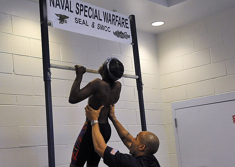 File:US Navy 100529-N-8689C-519 U.S. Navy SEAL assists a swimmer with pull-ups in the SEAL fitness challenge during the 8th annual National Black Heritage Championship Swim Meet.jpg