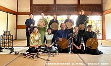 Group of Japanese folk musicians holding gekkin.