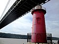 The Little Red Lighthouse under the George Washington Bridge. The bridge connects Washington Heights in Upper Manhattan across the Hudson River to Fort Lee, New Jersey, and is the world's busiest motor vehicle bridge.[1][2]