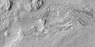 Surface breaking up, as seen by HiRISE under HiWish program Near the top the surface is eroding into brain terrain.