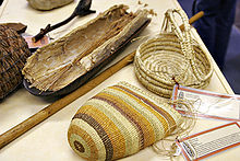 Aboriginal women's implements, including a coolamon lined with paperbark and a digging stick. This woven basket style is from Northern Australia. Baskets were used for collecting fruits, corms, seeds and even water - some baskets were woven so tightly as to be watertight. Aboriginal craft made from weaving grass.jpg