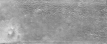 Aspledon Undae, a dune field near the Martian north pole. The bottom side of the image shows hundreds of small, isolated dunes. On the top side, these small dunes appear to have coalesced into larger dune forms. Aspledon Undae.jpg