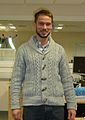 Man wearing shawl collar cardigan and hipster-inspired beard.