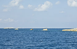 View of the Elbow Cays. The semi-ruined lighthouse of North Elbow Cay can be seen in the background.