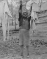 Child taking down the washing at evicted sharecroppers' camp. Butler County, Missouri LCCN2017779438 (cropped).tif