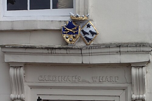 Male (shield-shaped) and female (lozenge-shaped) coats of arms in relief in Southwark, London.