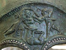Heracles and Apollo struggling over the Hind, as depicted on a Corinthian helmet (early 5th century BC) Corinthian helmet Cdm Paris BB2013 n2.jpg