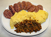 Boiled cotechino
(top) served with polenta and lentils Cotechino-Servito-Polenta-Lenticchie.jpg