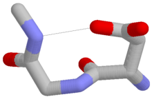 An Asx turn with an aspartate at residue i. One of the sidechain oxygens of the aspartate forms a hydrogen bond (dotted line) with the mainchain NH group of residue i+2. Colors: red, oxygen; grey, carbon; blue, nitrogen. Hydrogen atoms are omitted. Figure of asx-turn.png