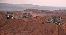 IDF Caterpillar D9R armored bulldozers carry out earthworks. Their heavy armor is developed and manufactured in Israel jointly by the Israel Defense Forces and Israeli defense industries. Flickr - Israel Defense Forces - D9s Hold Drill Near Gaza Border (1).jpg