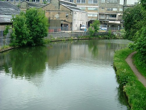 A modern view of the Grand Union Canal through Greenford, with the former J. Lyons & Co. factory in the background
