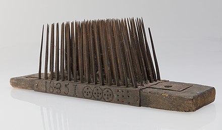 A hackle or heckle, a tool for threshing flax and preparing the fiber
