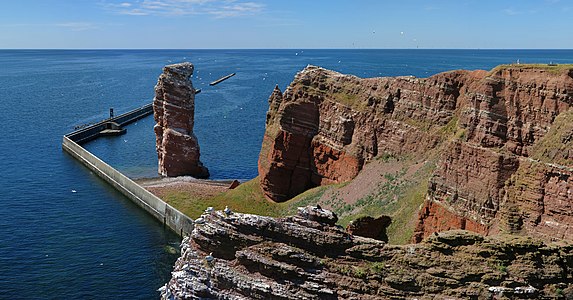 View from the "Lummenfelsen" called rock on the island of Heligoland to the Lange Anna with a large number of Northern gannets