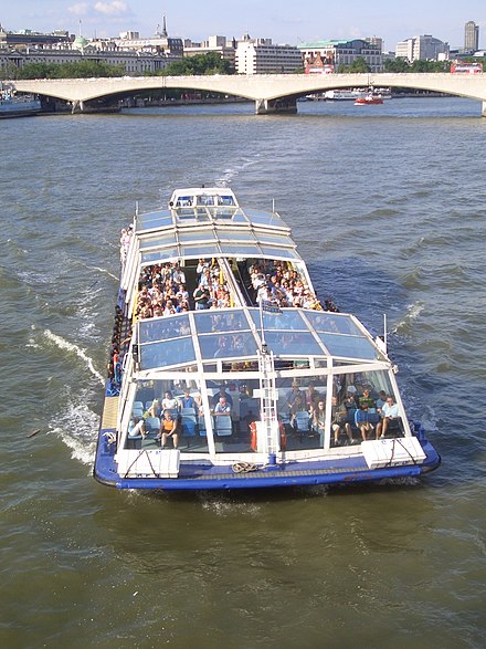 A tourist boat operated by Bateaux London Catamaran Cruisers on the River Thames