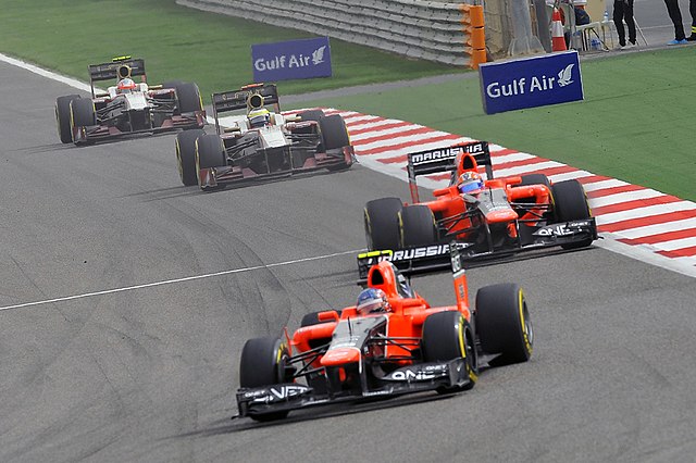 The Marussias of Charles Pic and Timo Glock leading the HRTs of Pedro de la Rosa and Narain Karthikeyan during the 2012 Bahrain Grand Prix