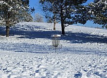 A disc golf basket in the snow at the Meri-Toppila course in Oulu Meri-Toppila Park Oulu 20170307 06.jpg