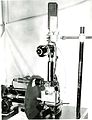 Close-up of NBS apparatus for filming metal fatigue tests, showing (from top) camera, eyepiece, microscope, fatigue-testing machine, and (left) revolving disc shutter.