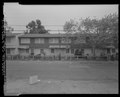 Part 2 of 3 of panorama with HABS CA-2783-D-1 and HABS CA-2783-D-3. View of north elevation of Building No. 9. Hinkley Avenue in foreground, looking south - Easter Hill Village, HABS CA-2783-D-2.tif