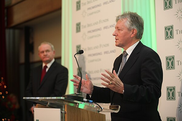 Robinson speaking at Titanic Belfast as Martin McGuinness looks on, 2012