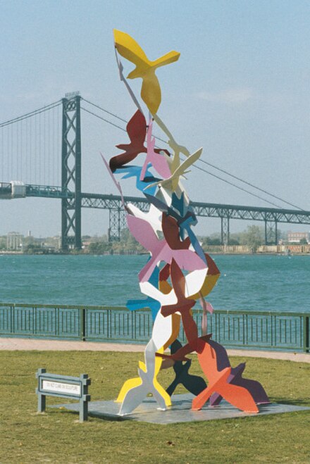 A seagull sculpture in Windsor's Odette Sculpture Park with a distant Ambassador Bridge crossing the river to Detroit, facing west-northwest.