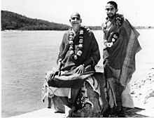 With Sivananda (seated on tiger skin) by the Ganges, c. 1950