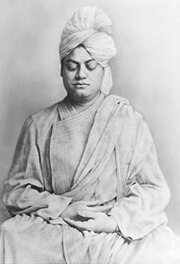 Formal photograph of Swami Vivekananda, eyes downcast