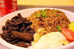 Tapsilog, a traditional Filipino breakfast combination with tapa, sinangag (garlic fried rice), and an egg omelet Tapsilog in saudi arabia.jpg