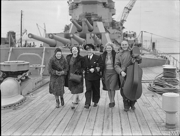 CEMA performers and a Royal Navy officer aboard the Duke of York at Scapa Flow