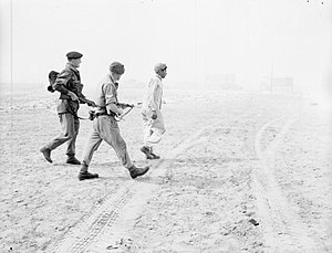 Troops of 3rd Battalion Parachute Regiment escort a captured Egyptian soldier on the beach at Port Said.jpg