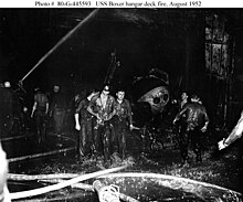 Crews battle a fire aboard Boxer's flight deck in August 1952. The fire, started by a fuel tank, killed 8 and damaged 18 aircraft.