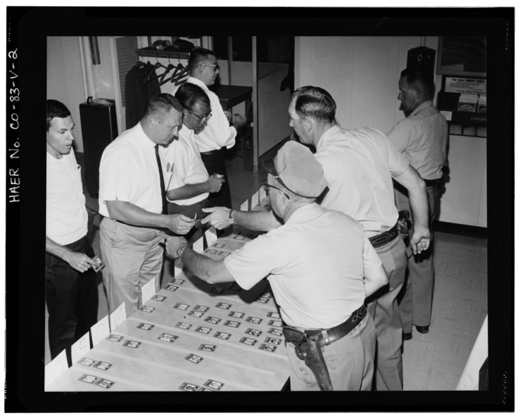 File:VIEW OF SITE EMPLOYEES CHECKING-IN IN THE CLOCK ROOM. EMPLOYEES WERE REQUIRED TO HAVE A SEPARATE BADGE FOR EACH AREA OF THE SITE THAT THEY ENTERED. (7-31-67) - Rocky Flats HAER COLO,30-GOLD.V,1V-2.tif