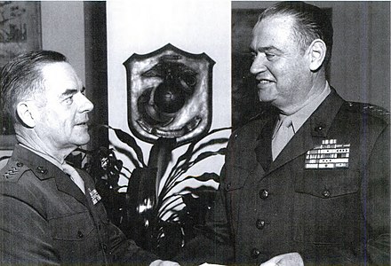 Commandant Wallace M. Greene congratulates Deputy Chief of Staff for Plans and Programs, Henry W. Buse Jr. on his promotion to lieutenant general on December 30, 1964.