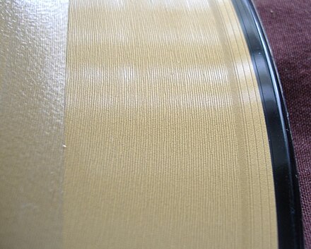 Close-up shot of a 12-inch (30 cm) single showing the wide grooves