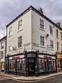 12 St Sampsons Square and 1A Church Street. Two houses with shops. 1836-39. Grade II listed.